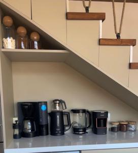 a kitchen counter with pots and pans on a shelf at Villa Han Selimiye in Selimiye