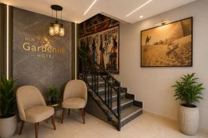 a lobby of a hotel with two chairs and a staircase at New Gardenia Pyramids - Rooftop in Cairo