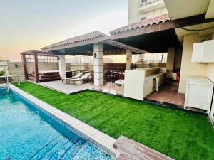 a backyard with a swimming pool and a house at Kiev Tower Hotel Apartments in Manama
