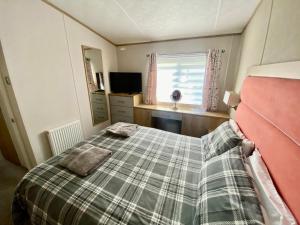 a bedroom with a bed and a window at Debran Lodge in Angus