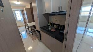 a small kitchen with a sink and a counter at Tey Spot in Iloilo City
