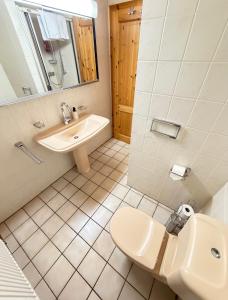 a bathroom with a sink and a toilet at Jagdhütte in Zöllnitz +10 photos