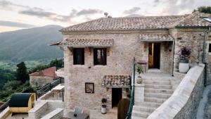 a stone house with a view at Valaes Guest House in Foiníkion
