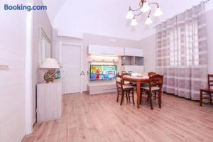 a kitchen and dining room with a table and chairs at Casa Serena in Amalfi +26 photos