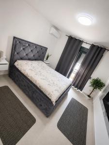 a bedroom with a bed and two rugs at Villa Hana in Bar