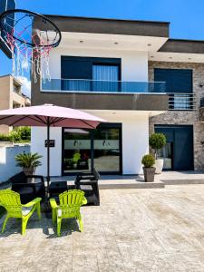 a basketball hoop and two chairs and an umbrella at Villa Hana in Bar