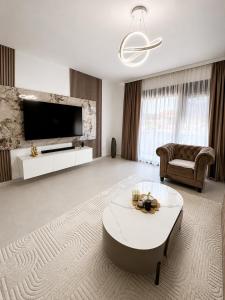 a living room with a large television and a table at Villa Hana in Bar