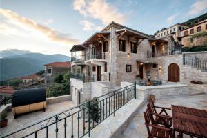 a house on a hill with a balcony at Valaes Guest House in Foiníkion +27 photos