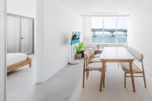a dining room with a table and chairs and a pier at 지니스테이 in Millak-tong