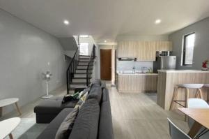 a living room with a couch and a kitchen at house luxury vip in Balayan