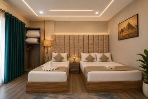 two beds in a room with green curtains at New Gardenia Pyramids - Rooftop in Cairo