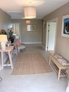 a living room with a table and a rug at Murreigh Beag Waterville in Waterville