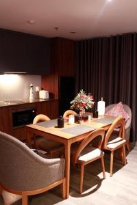 a dining room table with chairs and a kitchen at Casahindout in Hanoi +12 photos