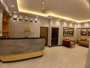 a lobby of a hotel with a reception desk at The Elet Express Luxury Hotel Apartments in Karachi