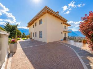 a house with a brick driveway in front of it at View & Chill Apartment in Riva del Garda