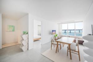 a dining room with a table and chairs and a bedroom at 지니스테이 in Millak-tong