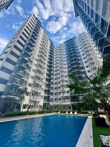 a large apartment building with a large swimming pool at Tey Spot in Iloilo City