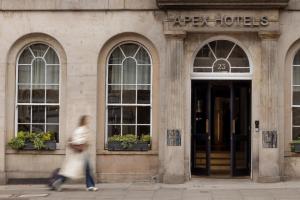 a person walking in front of a building at Apex Waterloo Place Hotel in Edinburgh