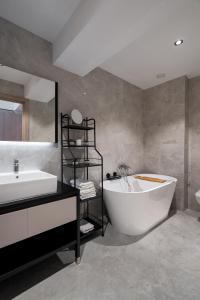 a bathroom with a large tub and a sink at Celeste Apartment 2BDR Parking in Bucharest