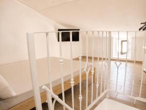 a white staircase with white railings in a room at Rallenta Casamassima in Casamassima +2 photos