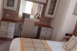 a bedroom with a bed and a desk and a mirror at 2-Bed Cabin - Sleeps 5 - Parking - Pet Friendly in Carnforth