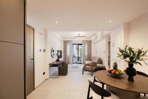 a living room with a table and a dining room at Avenue by Deserve in Paphos