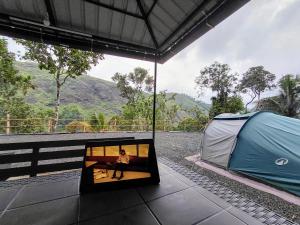 a tent with a person inside of it at Gandhara Tent camping in Vagamon