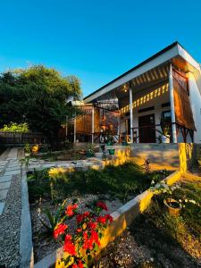 a house with flowers in front of it at Lomba Oen bungalow in Nembrala