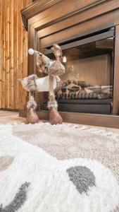 a stuffed animal standing in front of a fireplace at UMANI Retreat in Buşteni
