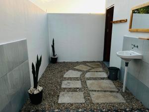 a bathroom with a toilet and a sink at Lomba Oen bungalow in Nembrala +21 photos