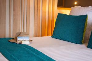 a hotel room with a bed with a book on it at Hôtel Le B d'Arcachon by Inwood Hotels in Arcachon