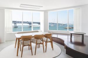 a dining room with a table and chairs and a bridge at 지니스테이 in Millak-tong