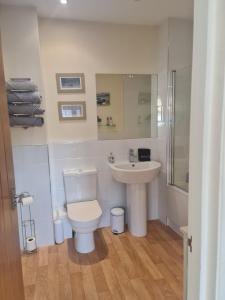 a bathroom with a toilet and a sink at Southcourt in Worthing