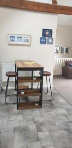 a living room with a table and two stools at Southcourt in Worthing +17 photos