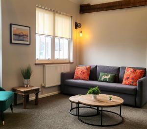 a living room with a couch and a table at Southcourt in Worthing