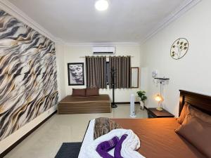 a bedroom with a bed with purple towels on it at Unmatched Location - A Large 2BR Sea-facing Flat in Sharjah