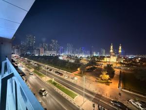 a view of a city at night with traffic at Unmatched Location - A Large 2BR Sea-facing Flat in Sharjah