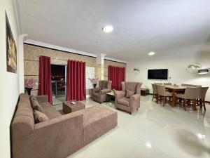a living room with a couch and a dining room at Unmatched Location - A Large 2BR Sea-facing Flat in Sharjah