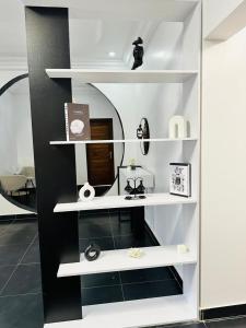 a white shelf with items on it in a room at Chez sesa in Dakar