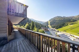 a balcony of a house with a view of the mountains at Hotel Zirbenhof in Hochfugen +68 photos