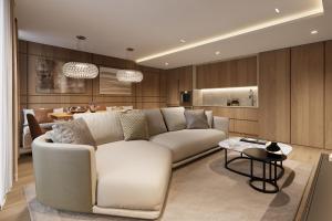 a living room with a white couch and a table at Campiglio PLAZA in Madonna di Campiglio