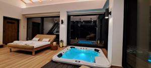 a living room with a tub in the middle of a room at Valdora Forest Oasis - Spa Villa Fužine in Fužine +67 photos