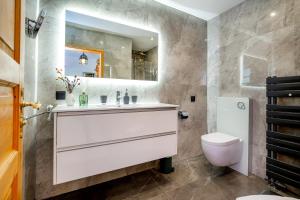 a bathroom with a white sink and a toilet at Villa Euphoria in Theológos