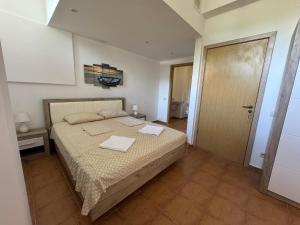a bedroom with a bed with two towels on it at VP Bellevue in Ravda