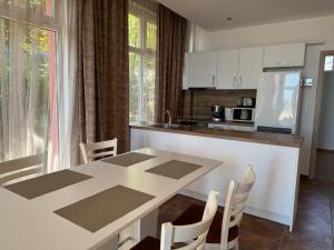 a kitchen with a table and chairs and a refrigerator at VP Bellevue in Ravda