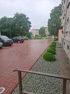 a brick parking lot with cars parked in a parking lot at SV Apartment in Jõhvi