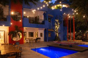 a house with a blue pool in front of it at Loman Art in Dakar