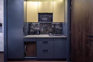 a kitchen with a sink and a microwave at Super Central - Modern & Luxury in Budapest