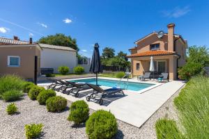 a villa with a swimming pool and a house at Villa Egli s bazenom in Kršan