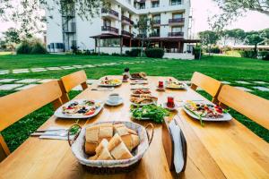 a wooden table with food on top of it at Helen Troya Hotel Geyikli in Çanakkale +48 photos